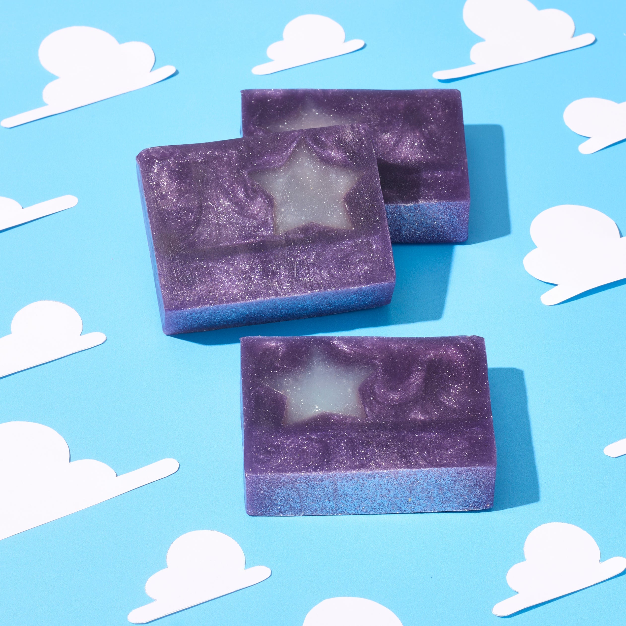 sparkling purple soap with a star embed on a cloud background